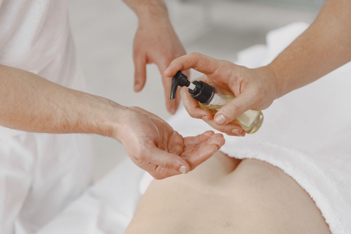 Therapist pumping massage oil into a palm, aroma massage Nerul, Sea Med Spa