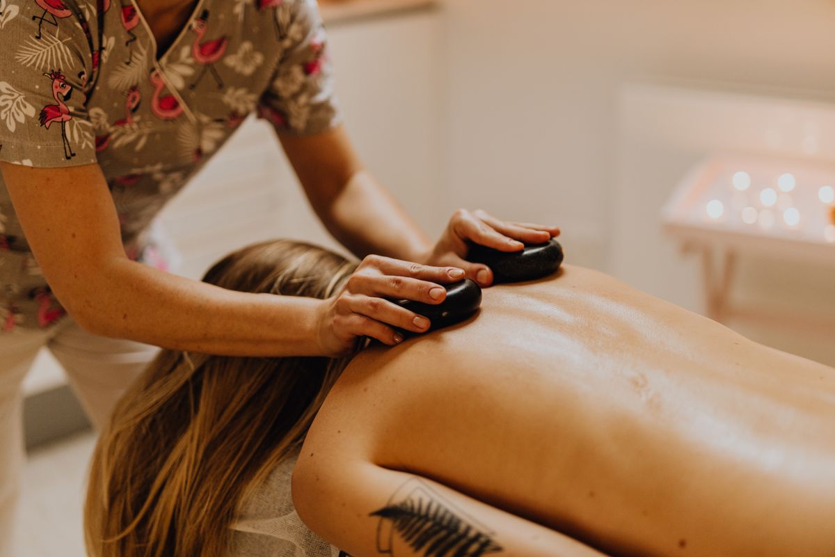 Stone massage session in a calm spa room, salt stone massage Kharghar