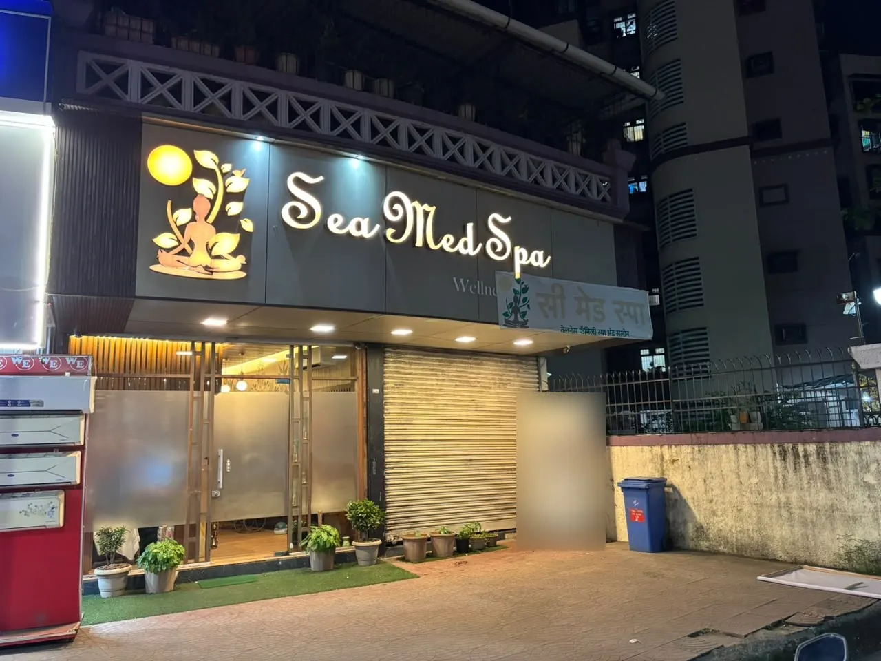 The Sea Med Spa Nerul storefront at night, lit signage above a glass entrance, opposite Haware Centurion Mall