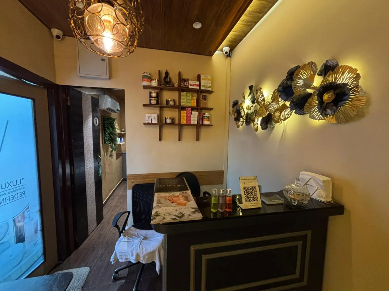 The Sector 7 reception desk, gold floral wall art and warm pendant lighting